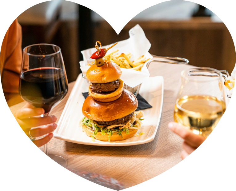 A burger and wine on a restaurant table